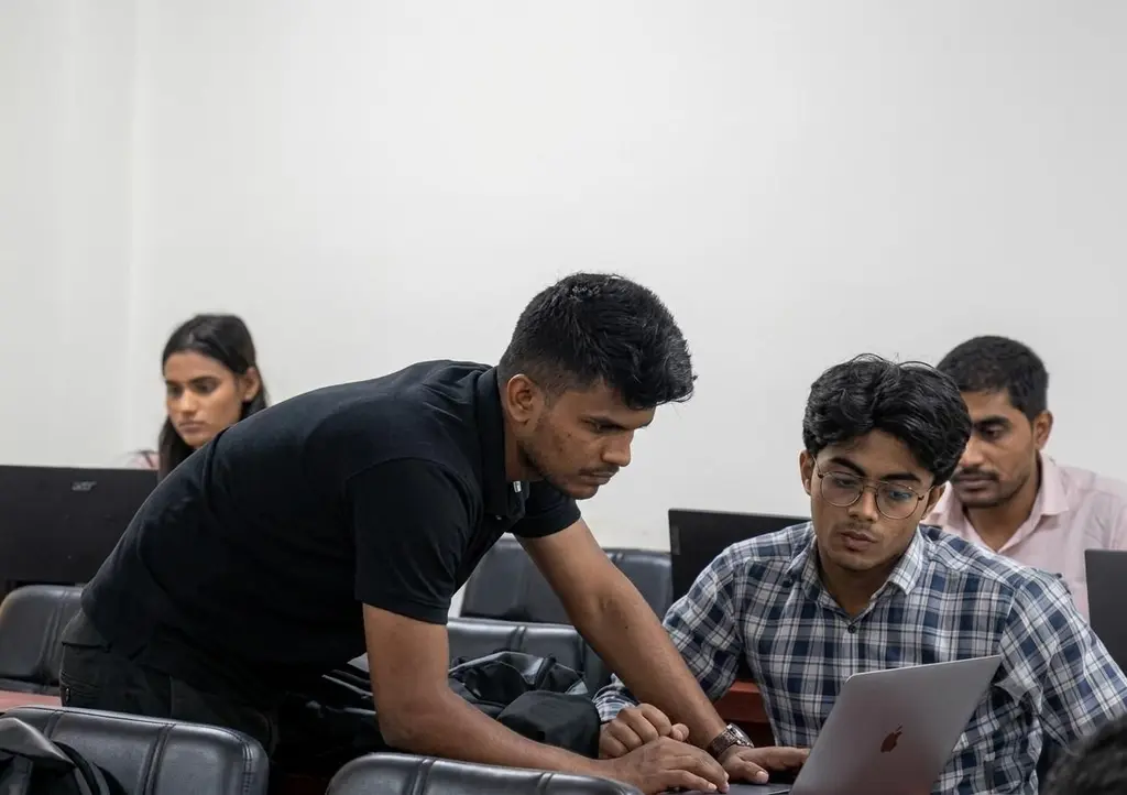 A mentor working through a business plan with students at the incubation centre